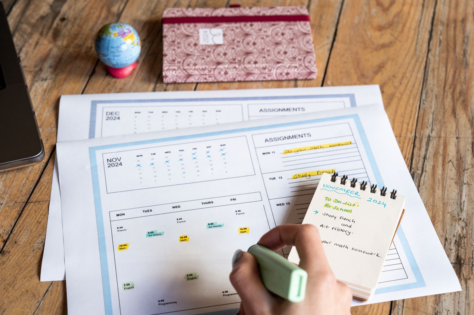 photographic | student sitting at a neat desk looking at a calendar and daily planner