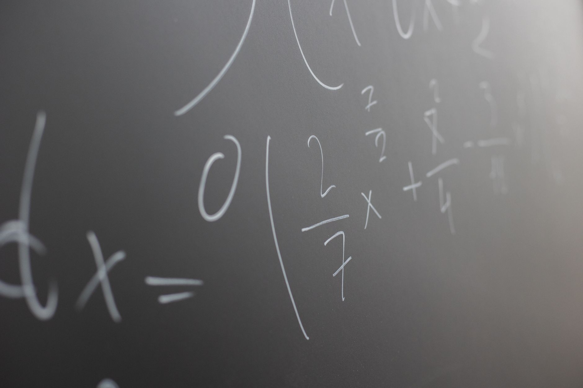 photographic | student explaining a math formula to a peer on a whiteboard