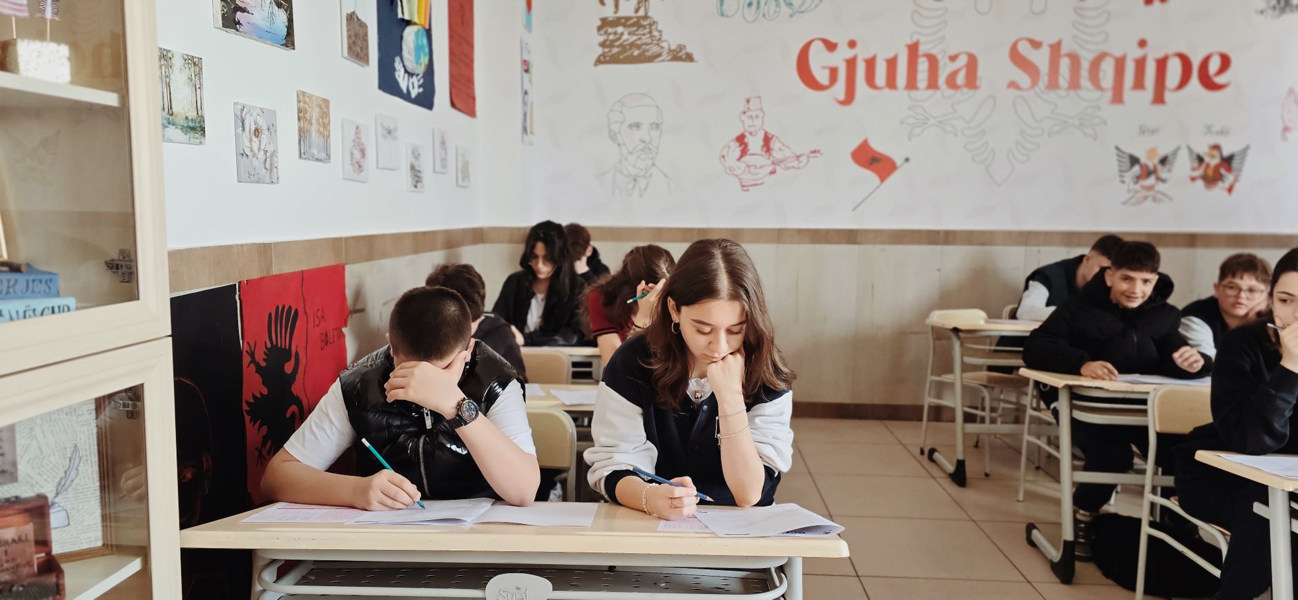 photographic | student studying with headphones on taking notes in a library setting