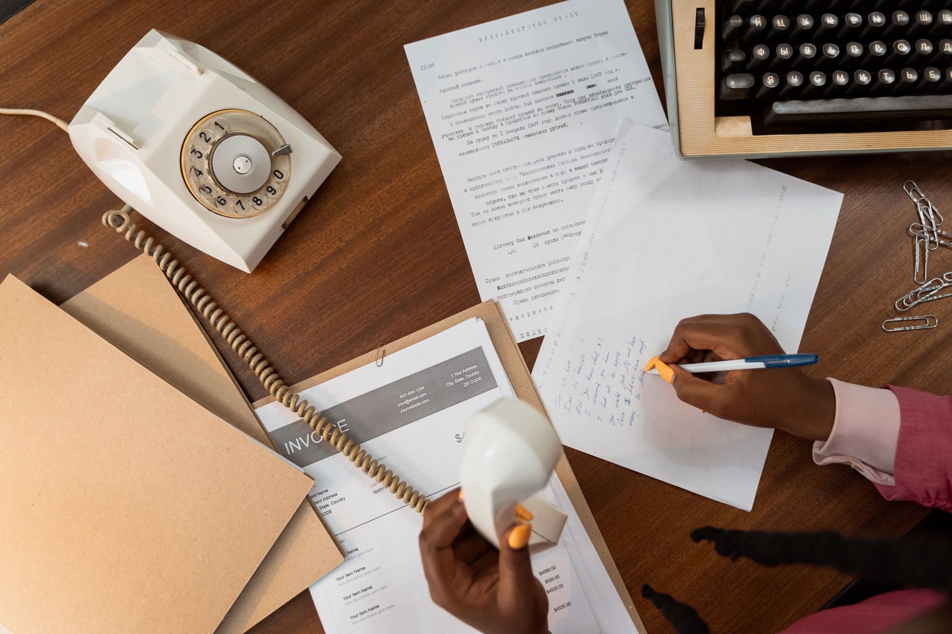 photographic | clean desk overhead view showing an academic resume, reference letter, and passport