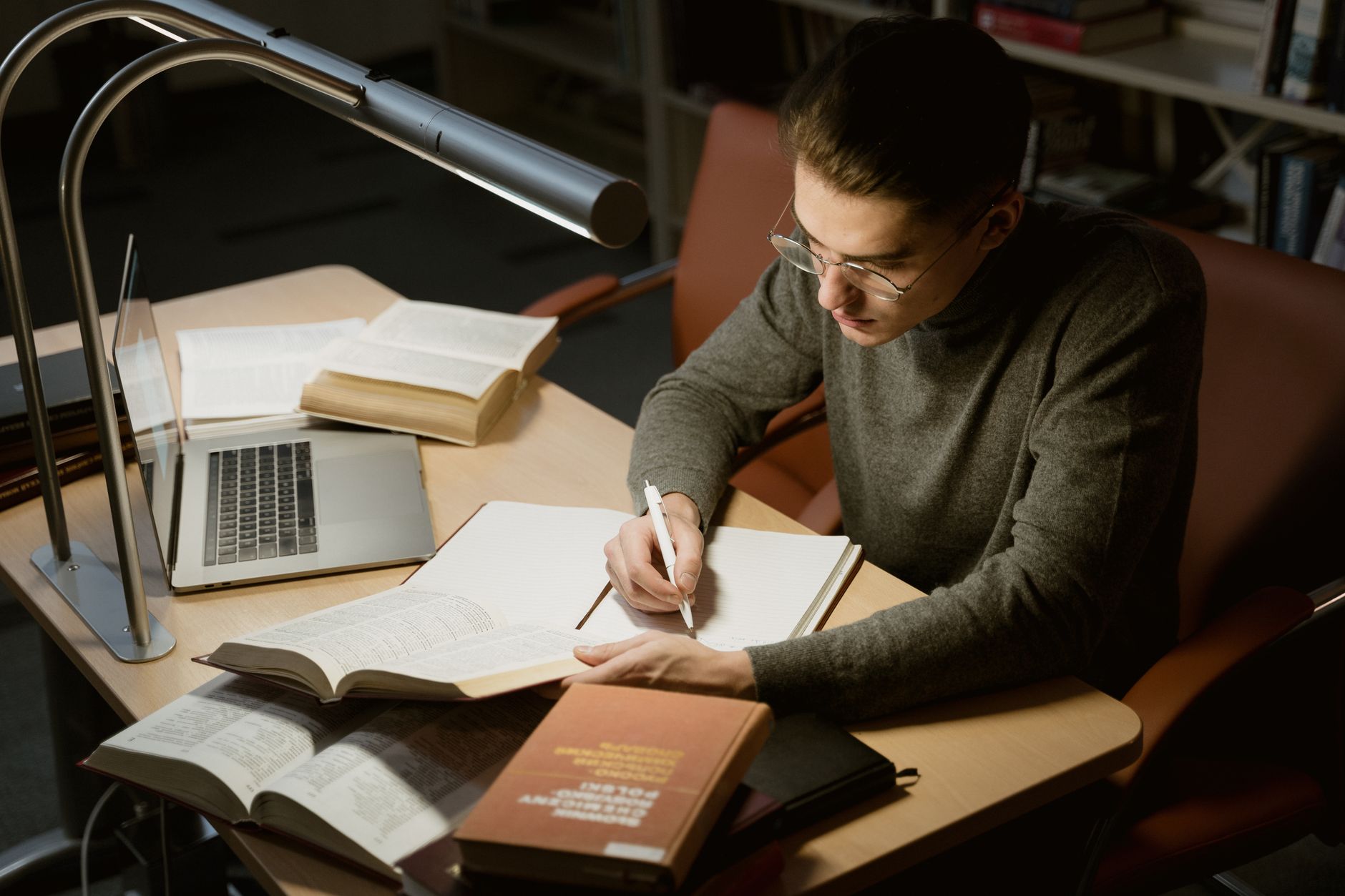 photographic | student taking a deep breath at a study desk right before an exam