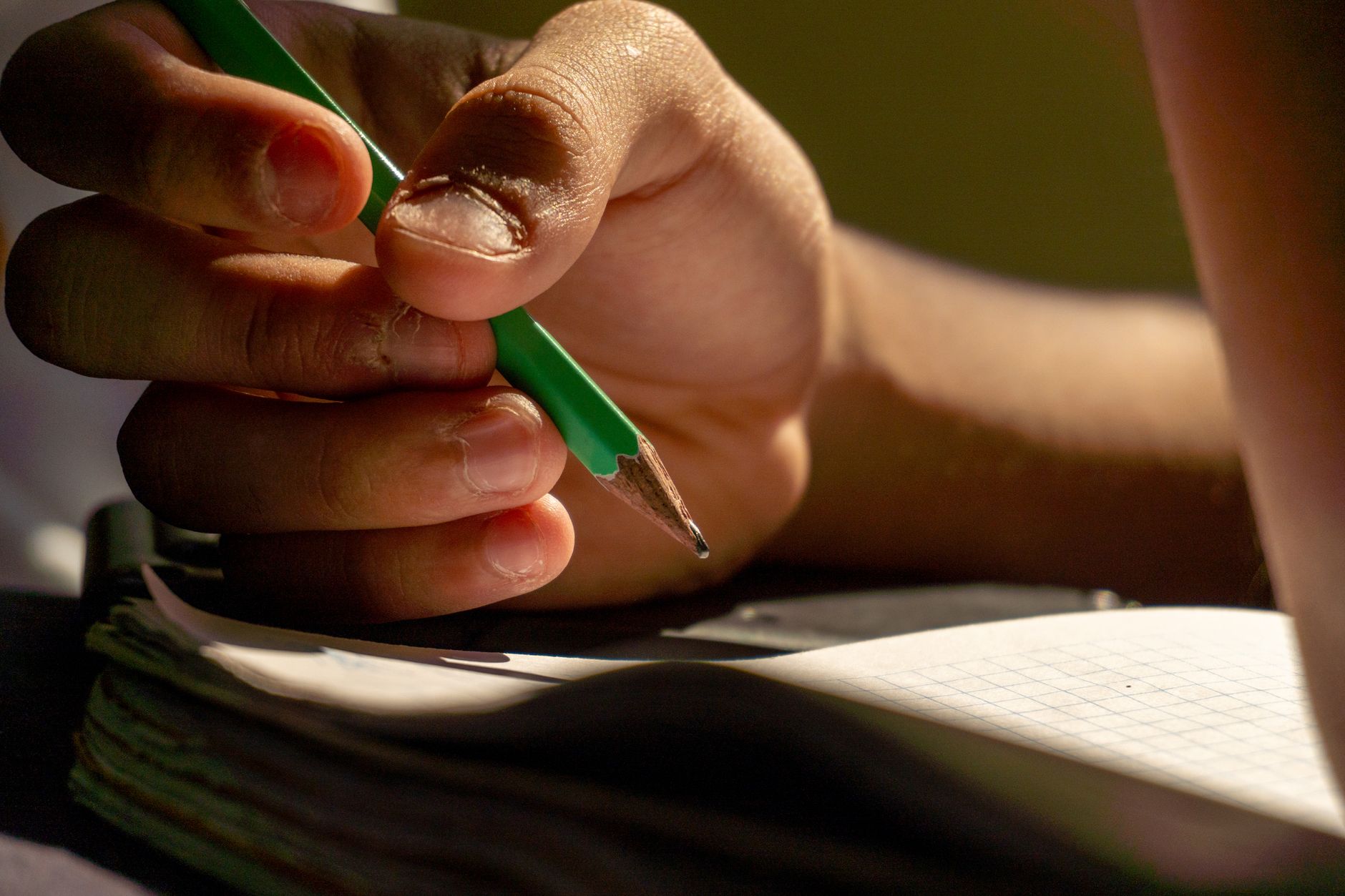 artistic | student plotting points on green graph paper with a wooden pencil